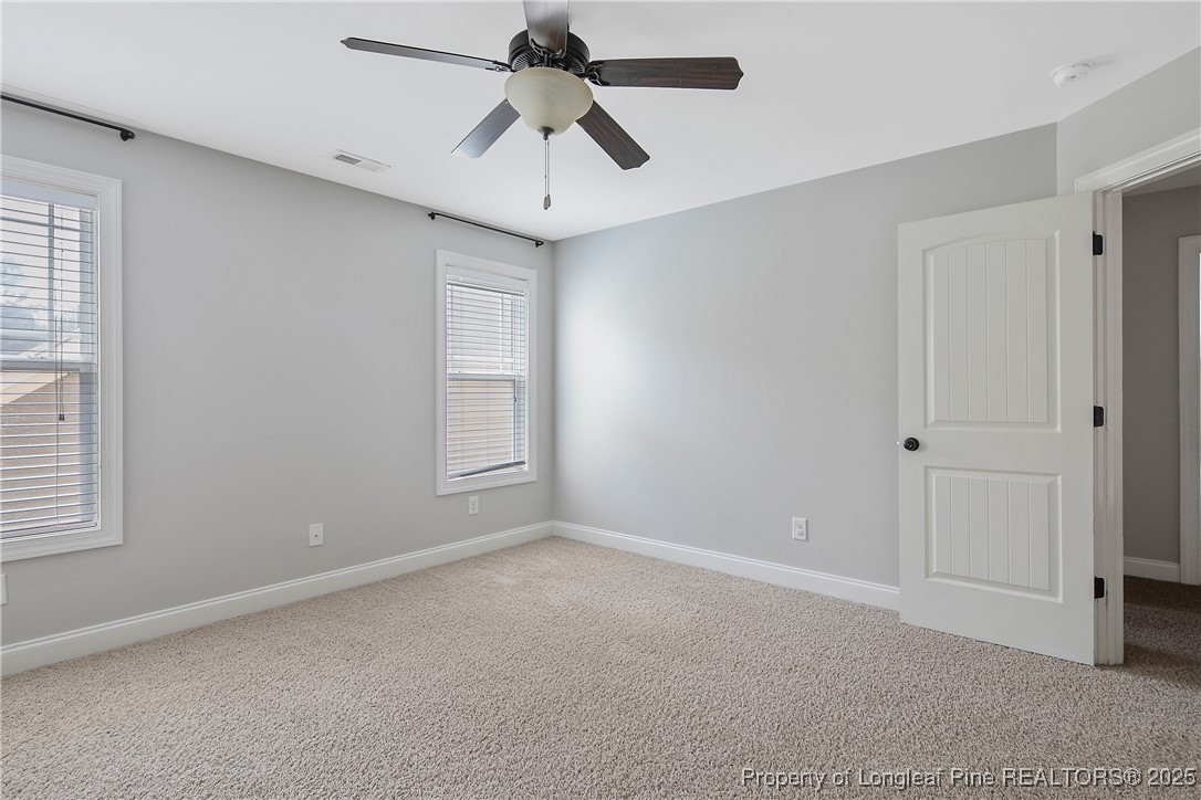 716 Micahs Way North Spring Lake, NC 28390 - Photo 42 of 50 an empty room with windows and fan