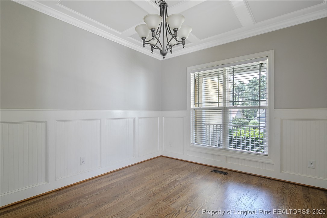716 Micahs Way North Spring Lake, NC 28390 - Photo 7 of 50 a view of an empty room with wooden floor and a window
