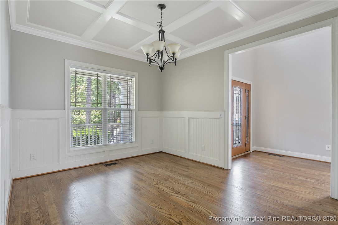 716 Micahs Way North Spring Lake, NC 28390 - Photo 8 of 50 a view of an empty room with wooden floor and a window
