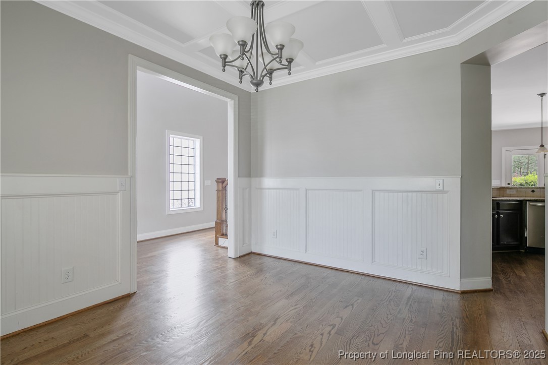 716 Micahs Way North Spring Lake, NC 28390 - Photo 9 of 50 wooden floor in an empty room with a window