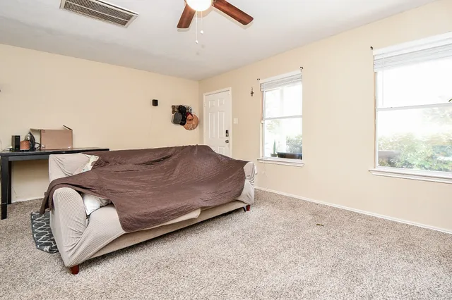 a spacious bedroom with a bed and window