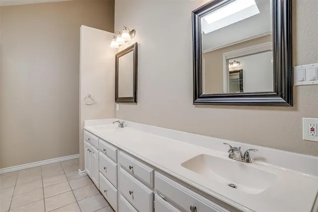 a bathroom with a double vanity sink mirror and