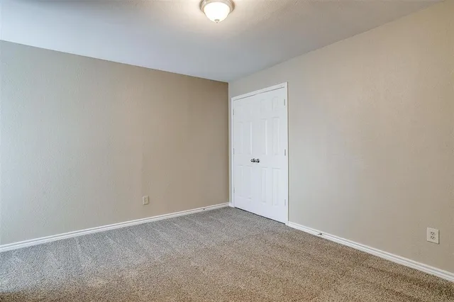 a view of an empty room and a fan