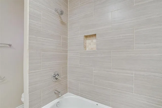 a bathroom with a bathtub and shower