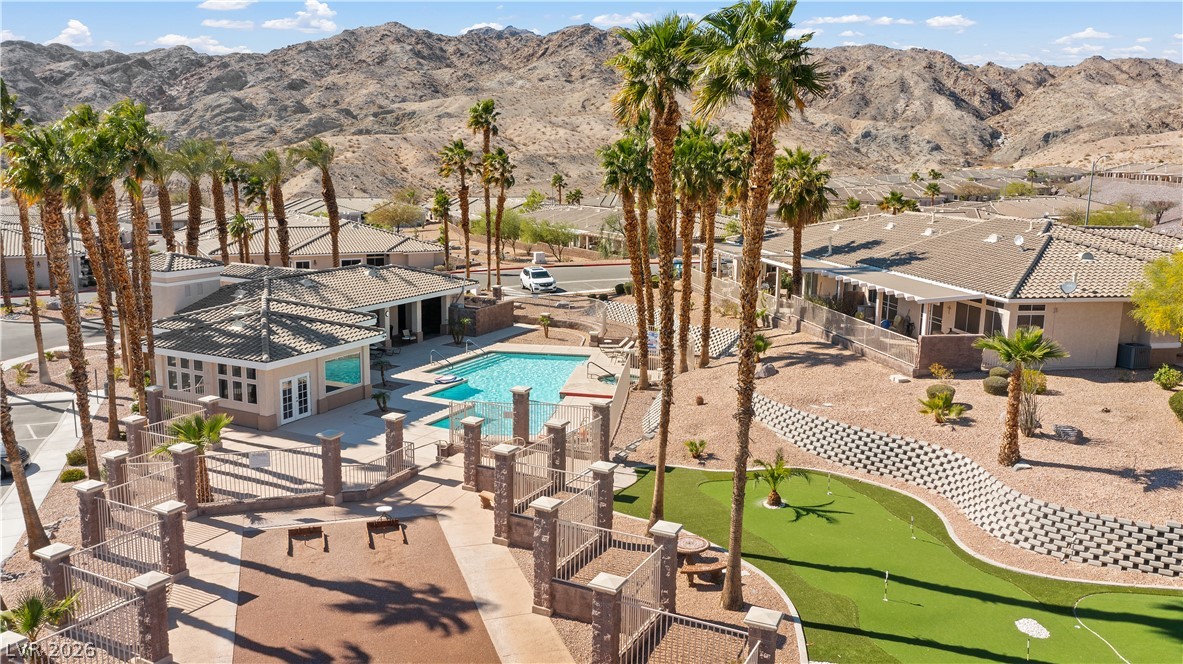 3376 Partridge Run Street Laughlin, NV 89029 - Photo 82 of 92 An inviting community pool and putting green offer leisure amid a desert landscape.