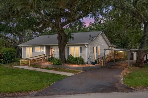 a front view of a house with yard and green space
