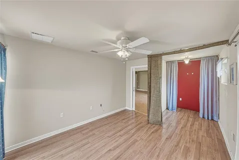 a view of a room with wooden floor and outdoor view