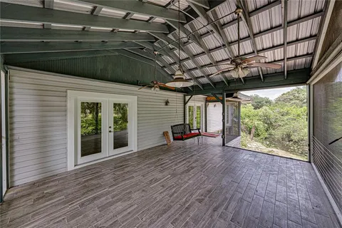 an aerial view of residential houses with outdoor space and trees