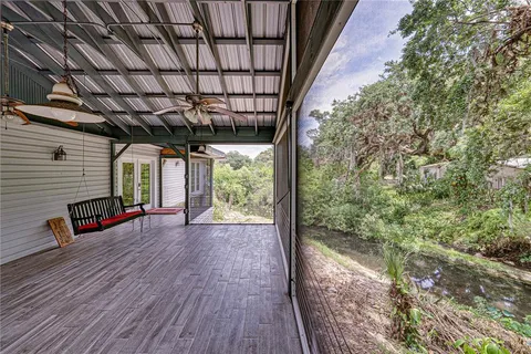 an aerial view of residential house with outdoor space and trees all around