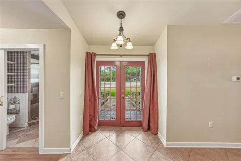 a view interior of a house wooden floor chandelier and windows