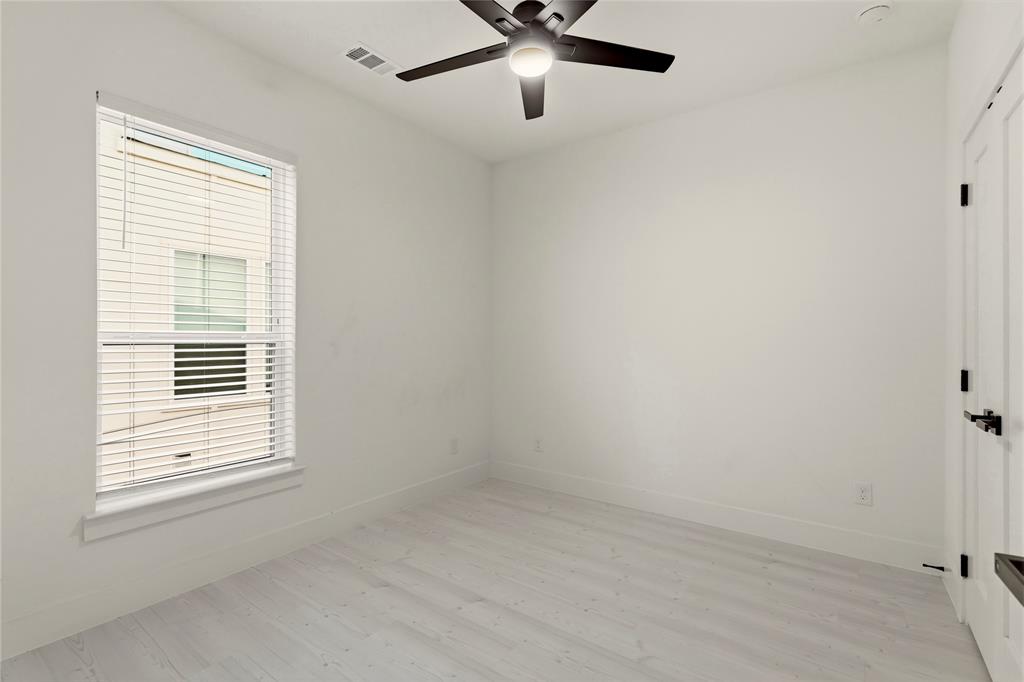 7207 Mohawk Drive, Unit B 3 Dallas, TX 75235 - Photo 16 of 19 an empty room with a window and a fan