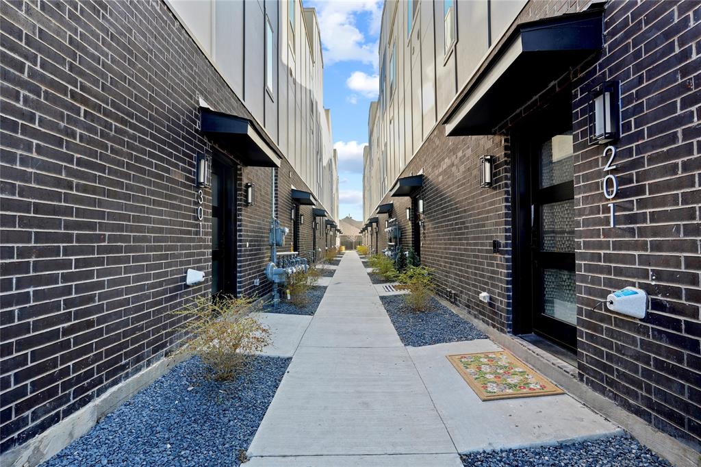 7207 Mohawk Drive, Unit B 3 Dallas, TX 75235 - Photo 3 of 19 a view of a pathway both side of building
