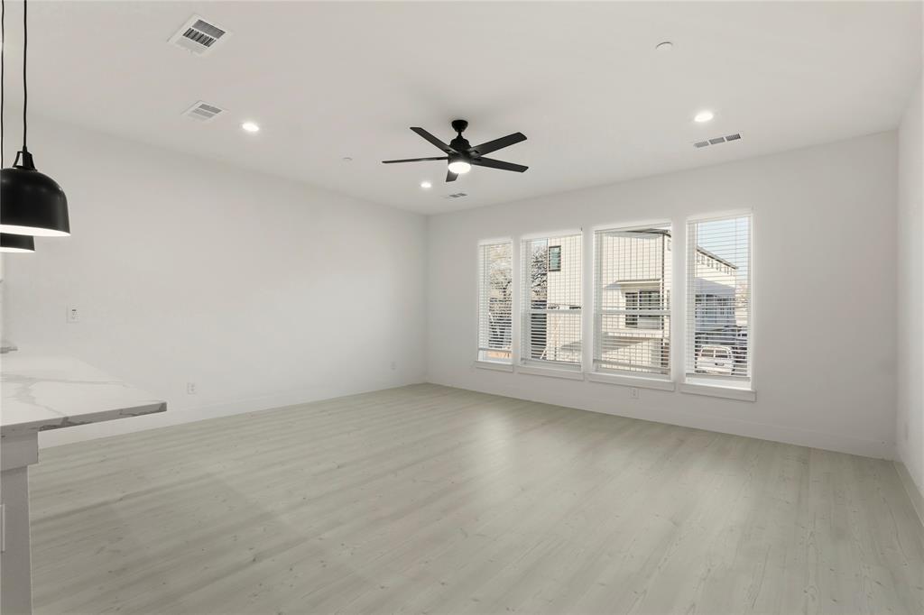 7207 Mohawk Drive, Unit B 3 Dallas, TX 75235 - Photo 6 of 19 an empty room with windows and ceiling fan