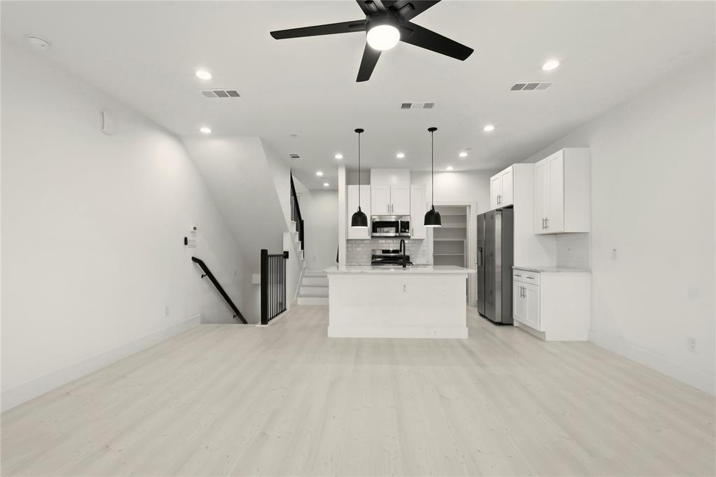 7207 Mohawk Drive, Unit B 3 Dallas, TX 75235 - Photo 19 of 19 a view of a kitchen with a refrigerator and a ceiling fan