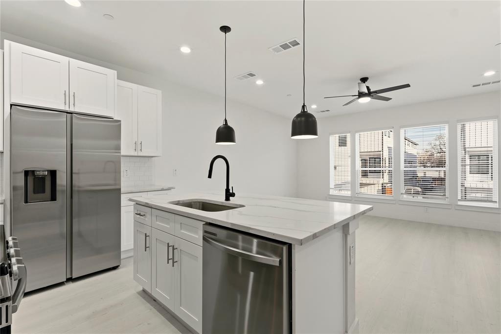 7207 Mohawk Drive, Unit B 3 Dallas, TX 75235 - Photo 9 of 19 a kitchen with stainless steel appliances granite countertop a sink a center island and a refrigerator