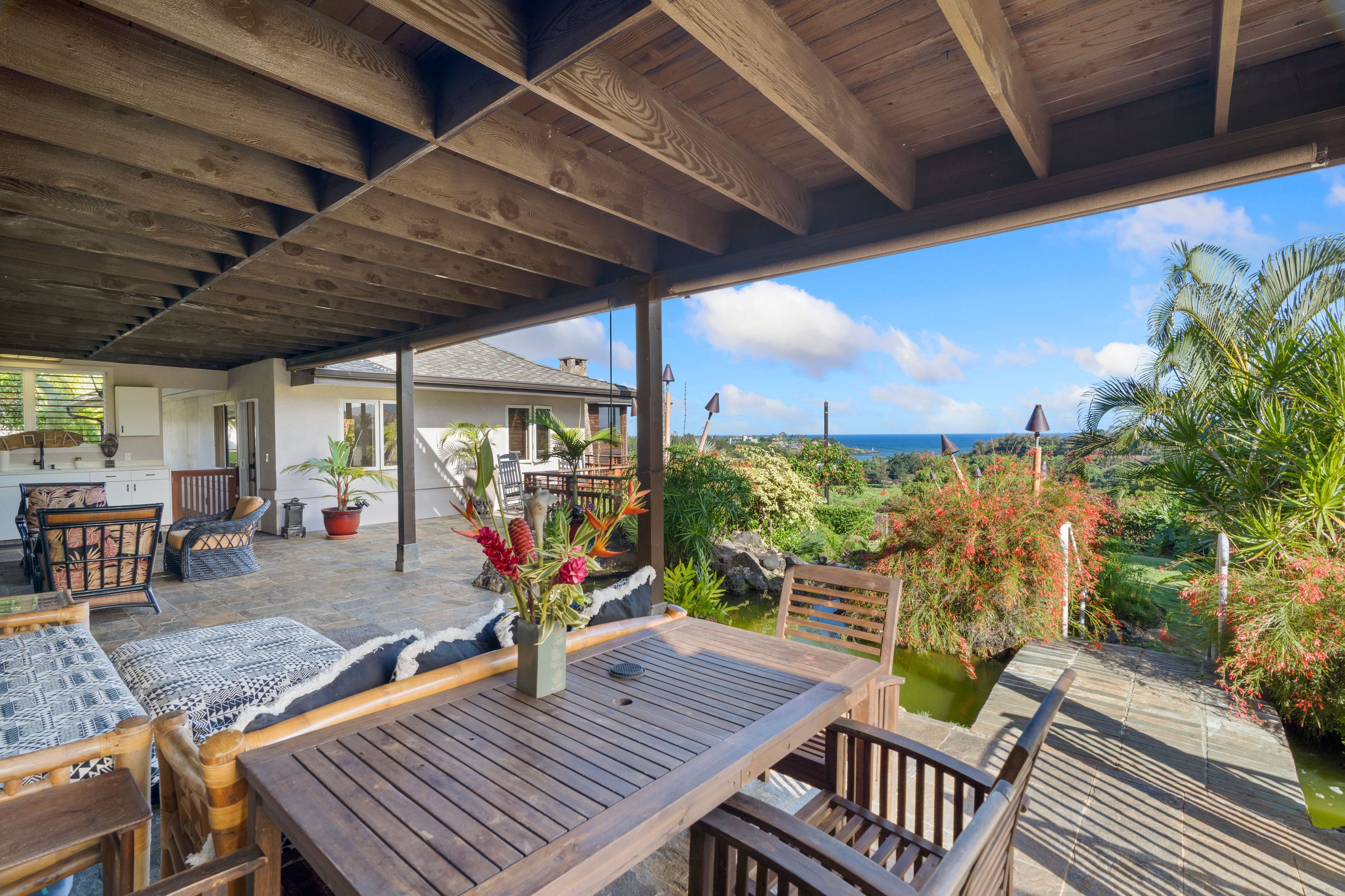 2938 Mokoi Street Lihue, HI 96766 - Photo 27 of 30 a view of a patio with table and chairs potted plants with wooden floor