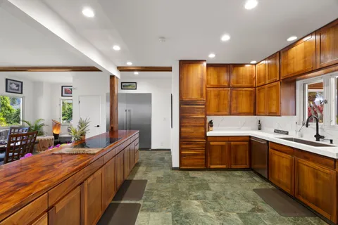 a kitchen that has a sink and a stove in it