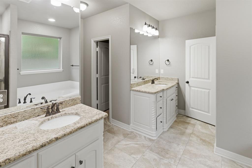 7765 Hickory Spring Lane Tyler, TX 75703 - Photo 26 of 38 Spacious bathroom featuring dual vanities with granite countertops, white cabinetry, and undermount sinks