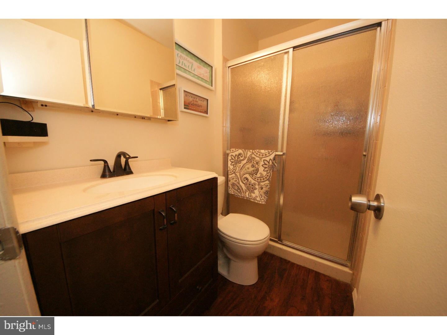 885 Jamestown Road East Windsor, NJ 08520 - Photo 16 of 25 a bathroom with a sink a toilet a mirror and shower