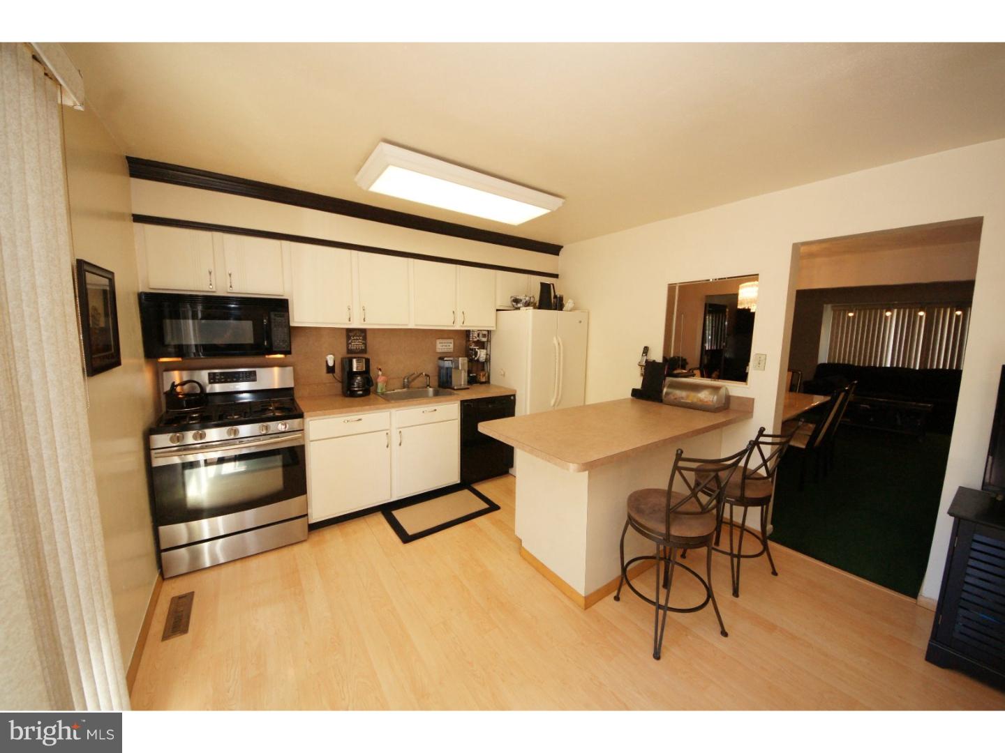 885 Jamestown Road East Windsor, NJ 08520 - Photo 7 of 25 a kitchen with a sink stainless steel appliances and white cabinets