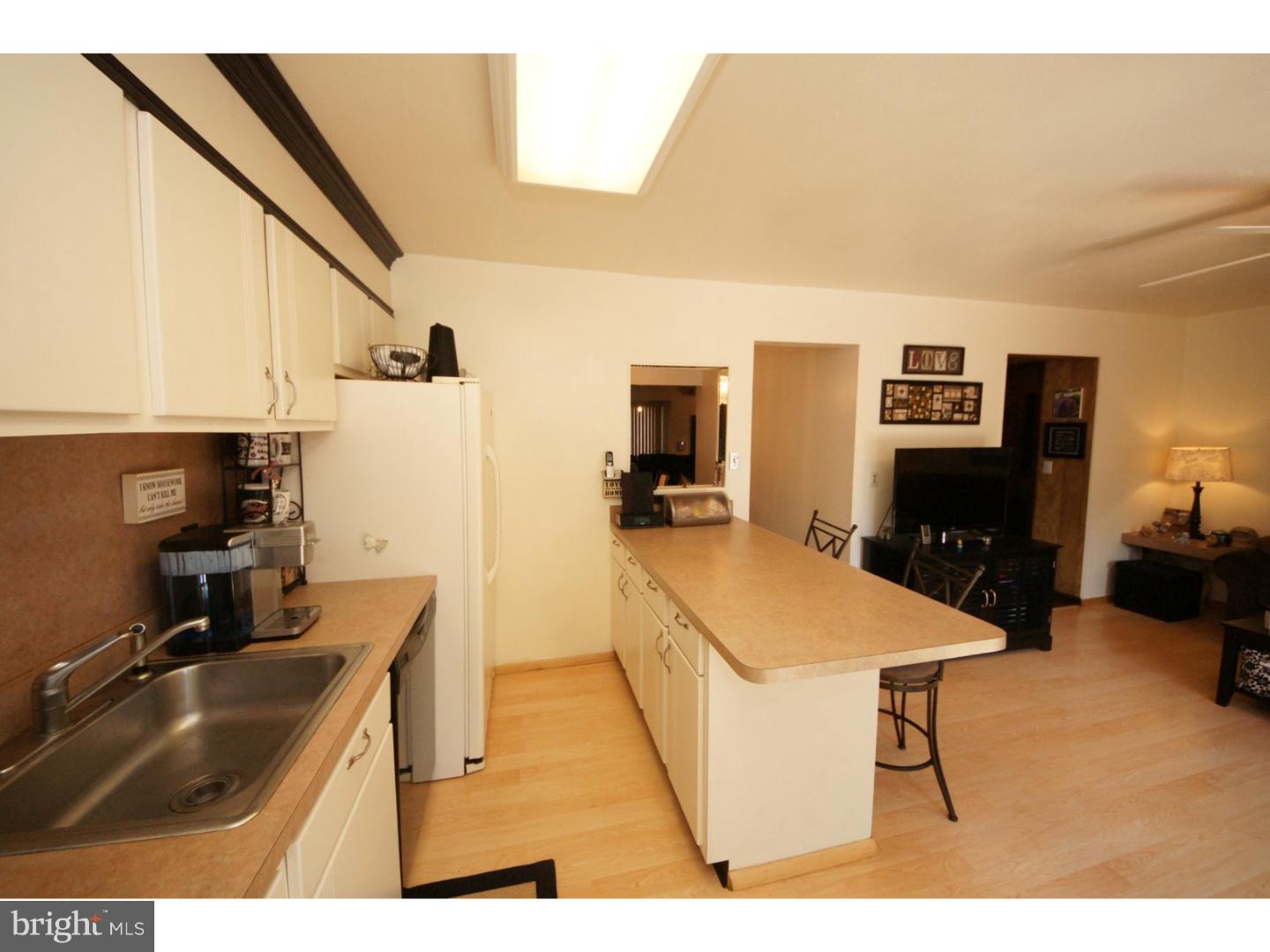 885 Jamestown Road East Windsor, NJ 08520 - Photo 8 of 25 a kitchen with a sink refrigerator and cabinets