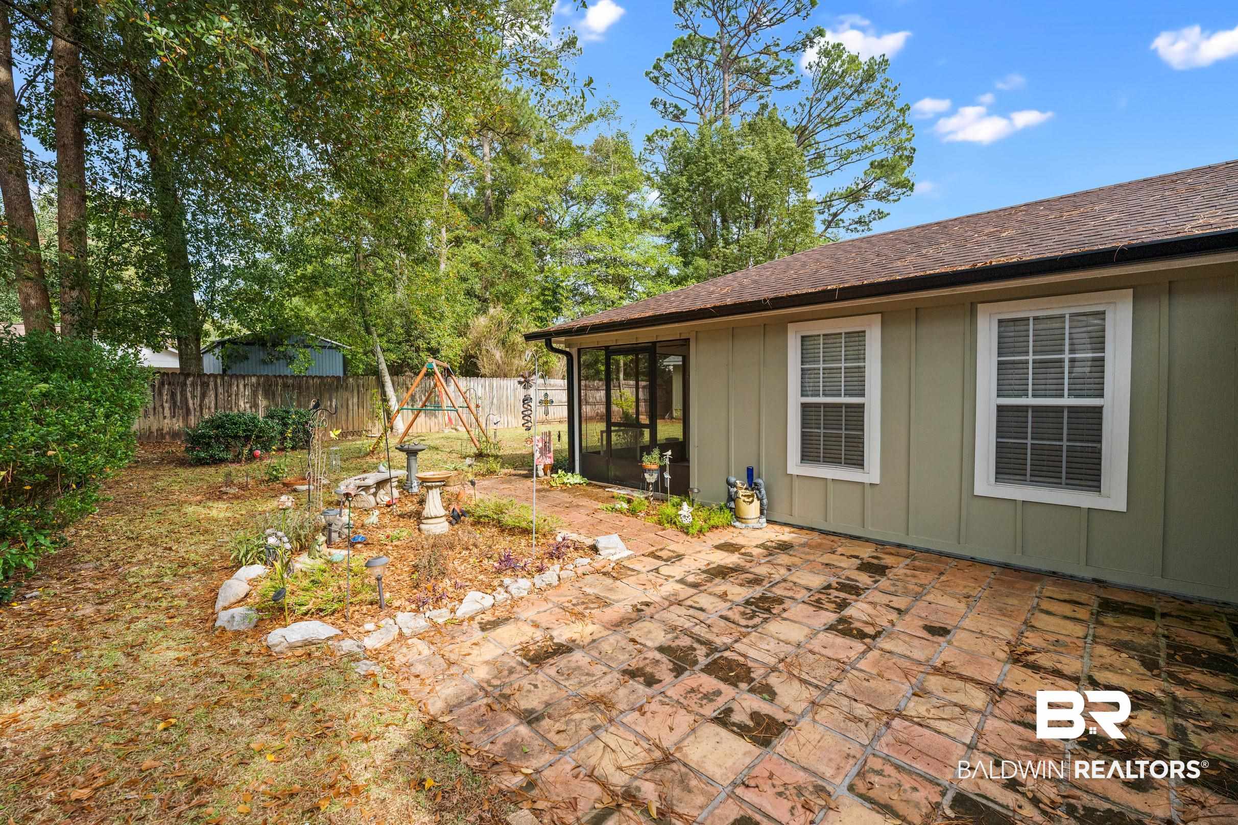 123 Dunbar Loop Daphne, AL 36526 - Photo 29 of 33 Fenced backyard featuring a sunroom and a patio