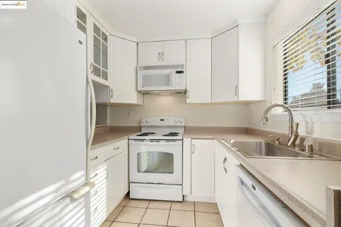 a kitchen with cabinets appliances and a sink