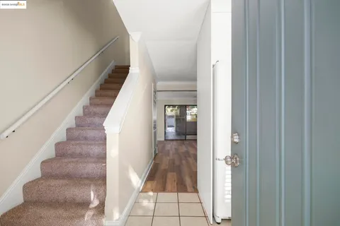 a view of a hallway with wooden floor and entryway