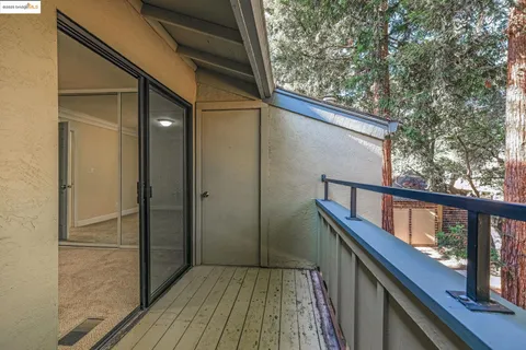 a balcony with wooden floor in front of it