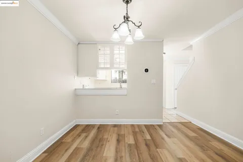 a view of wooden floor and chandelier in a room