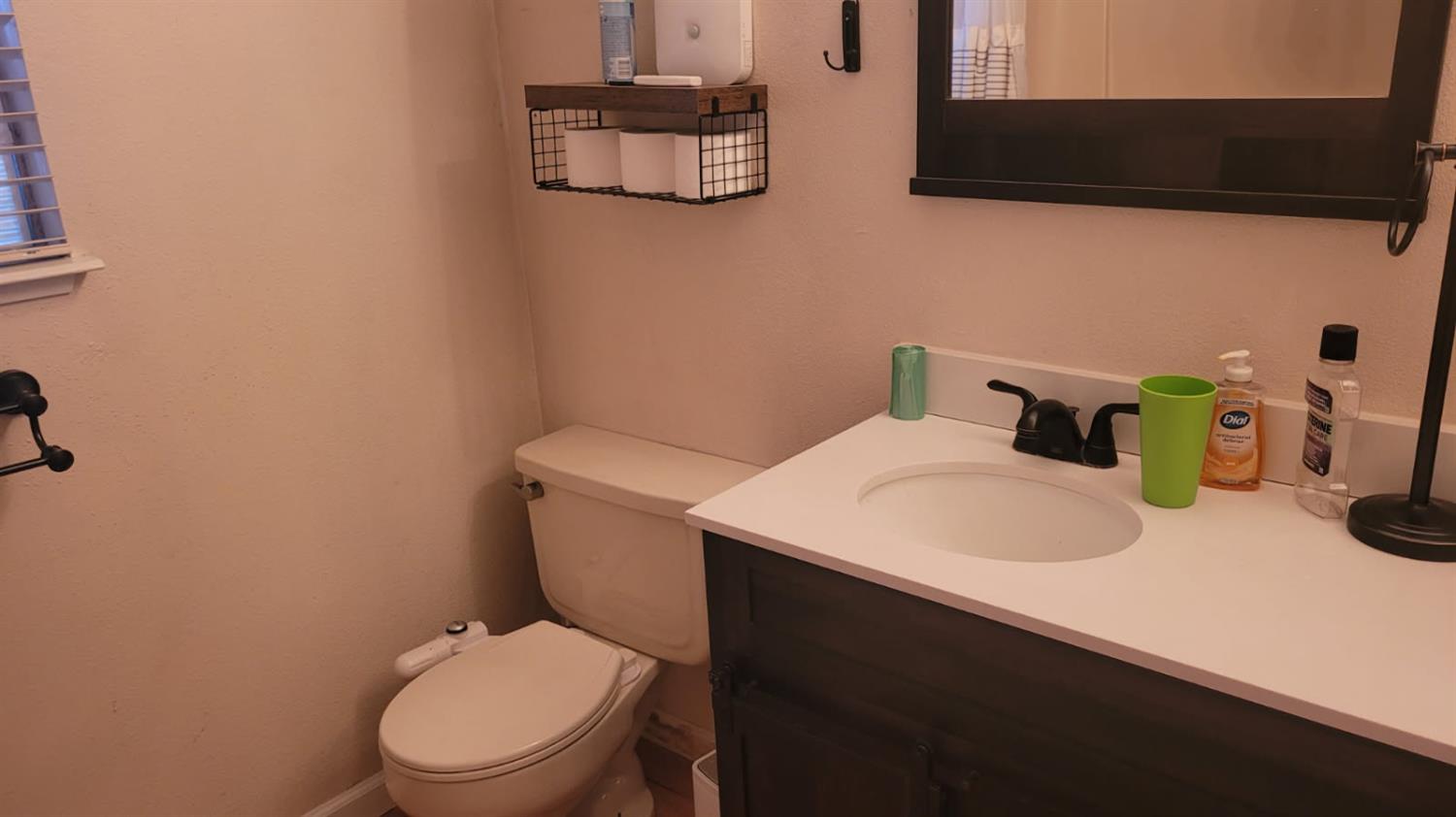 2786 Oak Street Anderson, CA 96007 - Photo 16 of 21 a white toilet sitting next to a bathroom sink