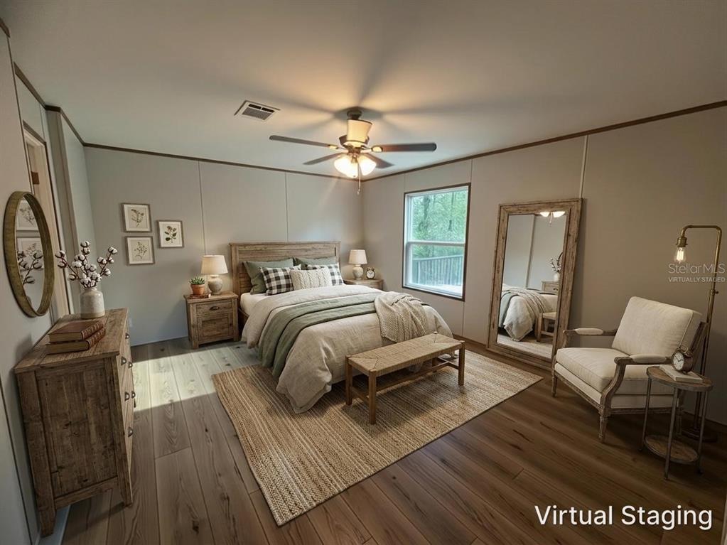 114 Nutmeg Trail Interlachen, FL 32148 - Photo 10 of 33 a bedroom with a bed a couch and dresser with wooden floor