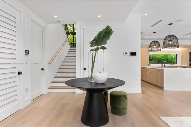 a living room with furniture kitchen view and a table