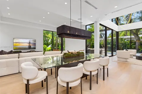 a living room with patio furniture and a potted plant