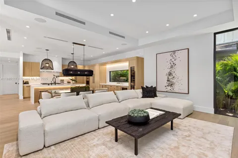 a spacious bedroom with a bed and a chandelier