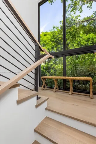 a patio with a table and chairs and potted plants
