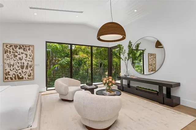 a backyard of a house with table and chairs under an umbrella