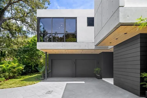 a kitchen with stainless steel appliances granite countertop a sink a stove a dining table and chairs with wooden floor