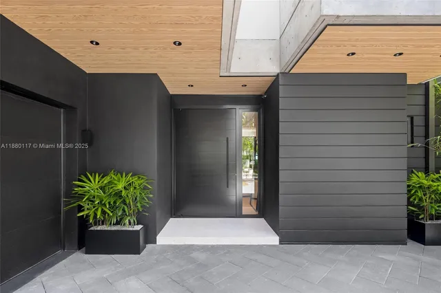 a kitchen with stainless steel appliances granite countertop a sink a stove and chairs with wooden floor