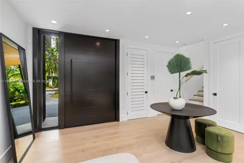 a kitchen with stainless steel appliances kitchen island granite countertop a table chairs and a chandelier