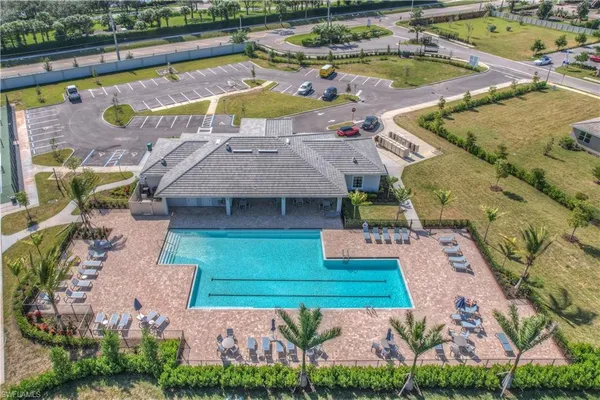 an aerial view of a house with a garden and lake view