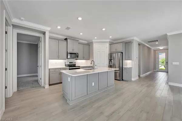 a kitchen with stainless steel appliances kitchen island granite countertop a stove a sink a refrigerator and a oven