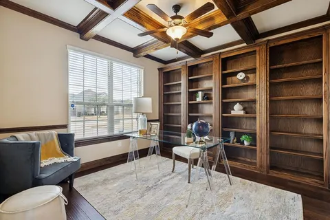 a living room with furniture a rug and a large window