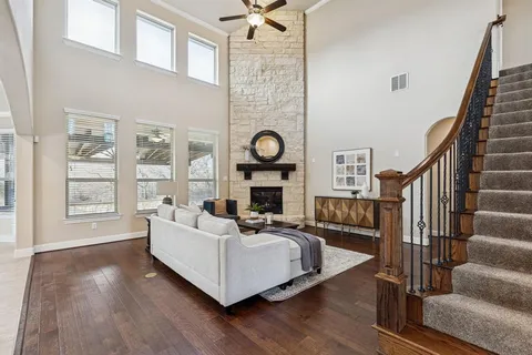 a living room with furniture wooden floor and a fireplace