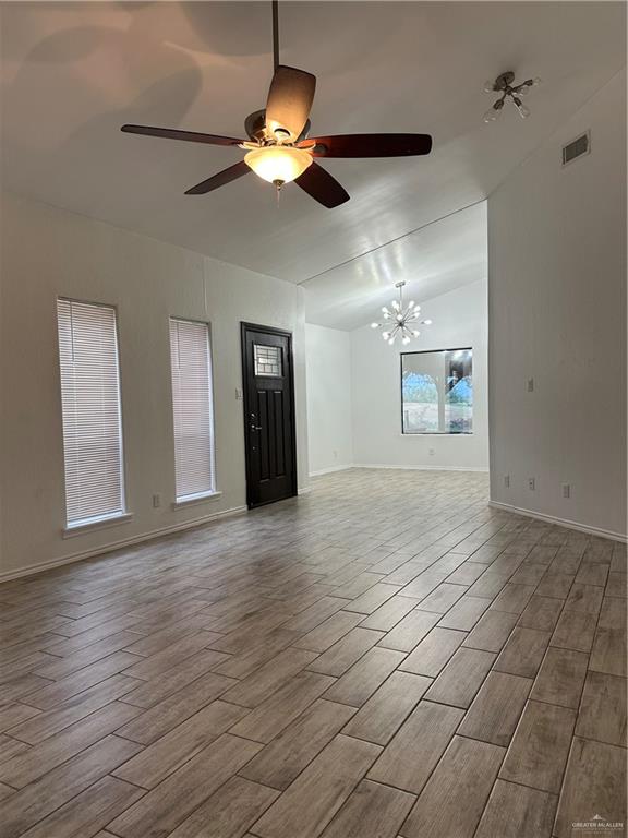 905 Colorado Court Mission, TX 78572 - Photo 14 of 42 a view of an empty room with a chandelier fan and a window