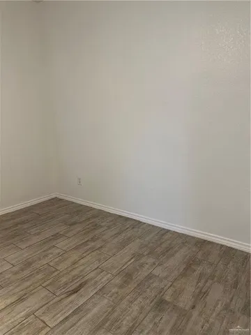 a view of room with wooden floor