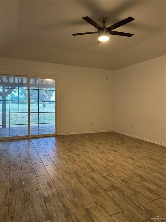 905 Colorado Court Mission, TX 78572 - Photo 27 of 42 an empty room with wooden floor and windows