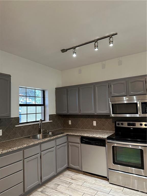 905 Colorado Court Mission, TX 78572 - Photo 29 of 42 a kitchen with granite countertop a stove sink and cabinets