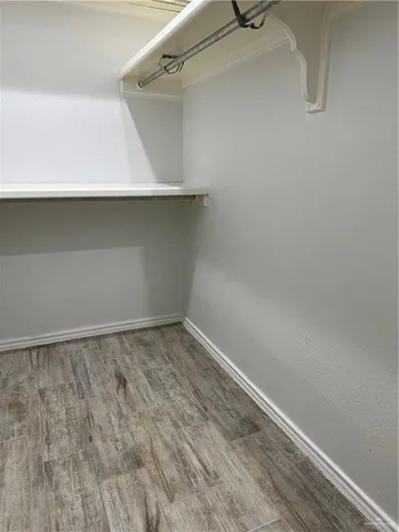 a white toilet sitting next to a white wooden wall