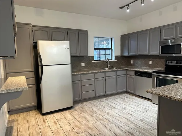 a view of kitchen with cabinets